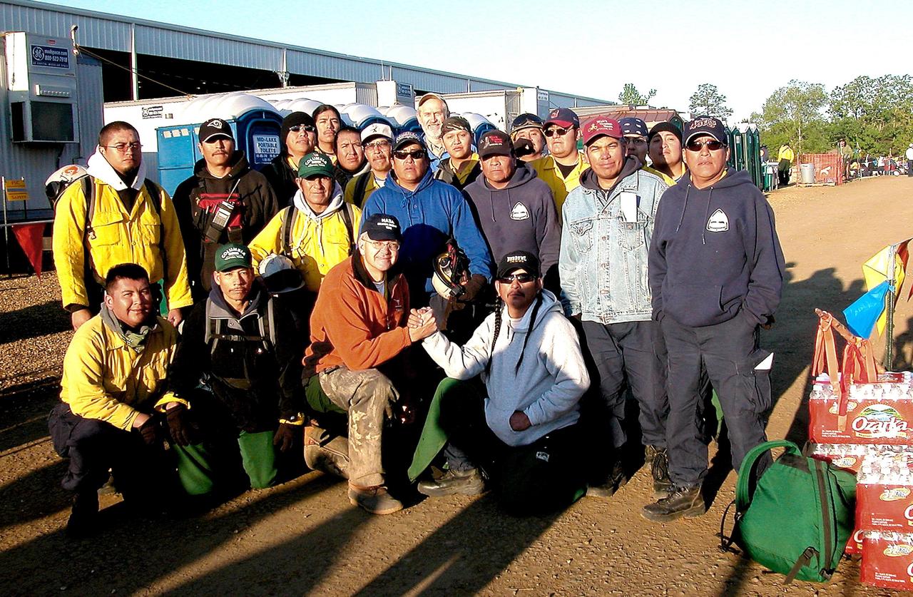 KENNEDY SPACE CENTER, FLA. --  David Mclaughlin, Prototype Lab technician at Kennedy Space Center, (center) poses with his Native American search team, the Laguna Firefighters from New Mexico, at the Hemphill site. Kennedy Space Center workers are participating in the Columbia Recovery efforts at the Lufkin (Texas) Command Center, four field sites in East Texas, and the Barksdale, La., hangar site. KSC is working with representatives from other NASA Centers and with those from a number of federal, state and local agencies in the recovery effort. KSC provides vehicle technical expertise in the field to identify, collect and return Shuttle hardware to KSC.