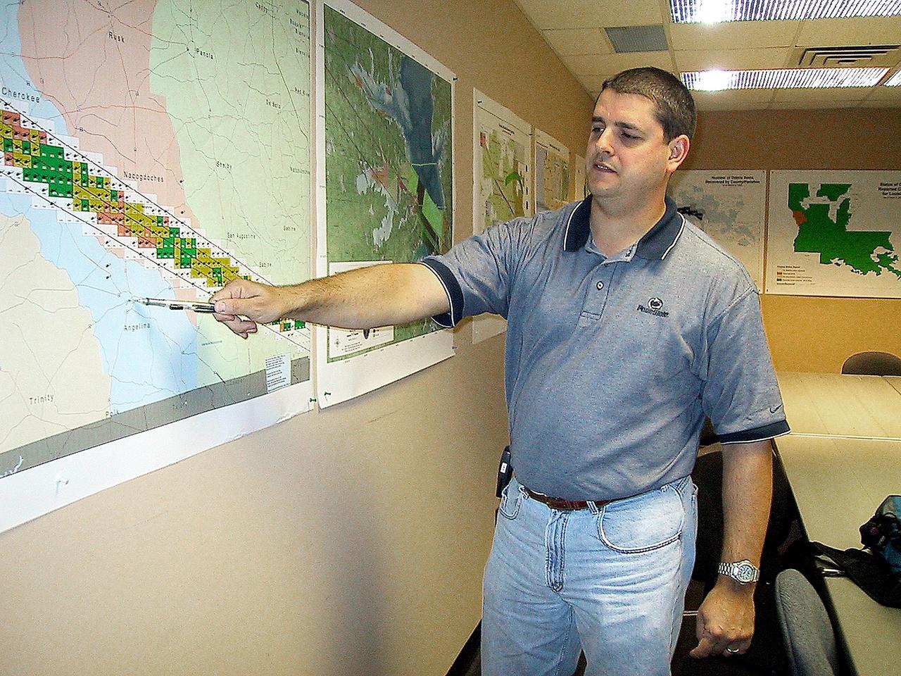 KENNEDY SPACE CENTER, FLA. -- Jeff Angermeier, assigned to lead the ground operations at the Lufkin Command Center, points out a town near the Columbia debris field. KSC workers are participating in the Columbia Recovery efforts at the Lufkin (Texas) Command Center, four field sites in East Texas, and the Barksdale, La., hangar site. KSC is working with representatives from other NASA Centers and with those from a number of federal, state and local agencies in the recovery effort. KSC provides vehicle technical expertise in the field to identify, collect and return Shuttle hardware to KSC.