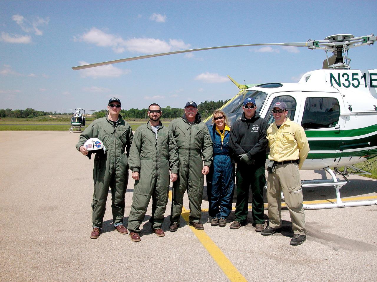 KENNEDY SPACE CENTER, FLA. -- Kennedy Space Center and Forest Service workers pose in front of a helicopter landed at the Nacogdoches field site. The helicopter is one of those being used to survey for parts of Columbia. KSC workers are participating in the Columbia Recovery efforts at the Lufkin (Texas) Command Center, four field sites in East Texas, and the Barksdale, La., hangar site. KSC is working with representatives from other NASA Centers and with those from a number of federal, state and local agencies in the recovery effort. KSC provides vehicle technical expertise in the field to identify, collect and return Shuttle hardware to KSC.