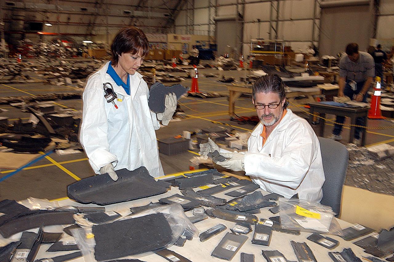 KENNEDY SPACE CENTER, FLA. -- Members of the Columbia Reconstruction Project team continue their work identifying pieces of Columbia debris delivered to the RLV Hangar. Shipped from Barksdale Air Force Base, Shreveport, La., more than 70,000 items, weighing 78,000 pounds, about 36 percent of the Shuttle by weight, have been delivered to KSC for use in the mishap investigation. Ground teams have completed 78 percent of their primary search area, and airborne crews finished 80 percent of their assigned area. Search teams have completed 98 percent of the underwater searches in Lake Nacogdoches and Toledo Bend Reservoir.