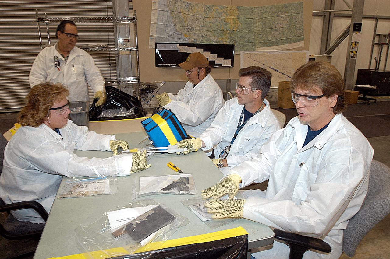 KENNEDY SPACE CENTER, FLA. -- Members of the Columbia Reconstruction Project team continue their work to identify pieces of Columbia debris delivered to the RLV Hangar. Shipped from Barksdale Air Force Base, Shreveport, La., more than 70,000 items, weighing 78,000 pounds, about 36 percent of the Shuttle by weight, have been delivered to KSC for use in the mishap investigation. Ground teams have completed 78 percent of their primary search area, and airborne crews finished 80 percent of their assigned area. Search teams have completed 98 percent of the underwater searches in Lake Nacogdoches and Toledo Bend Reservoir.