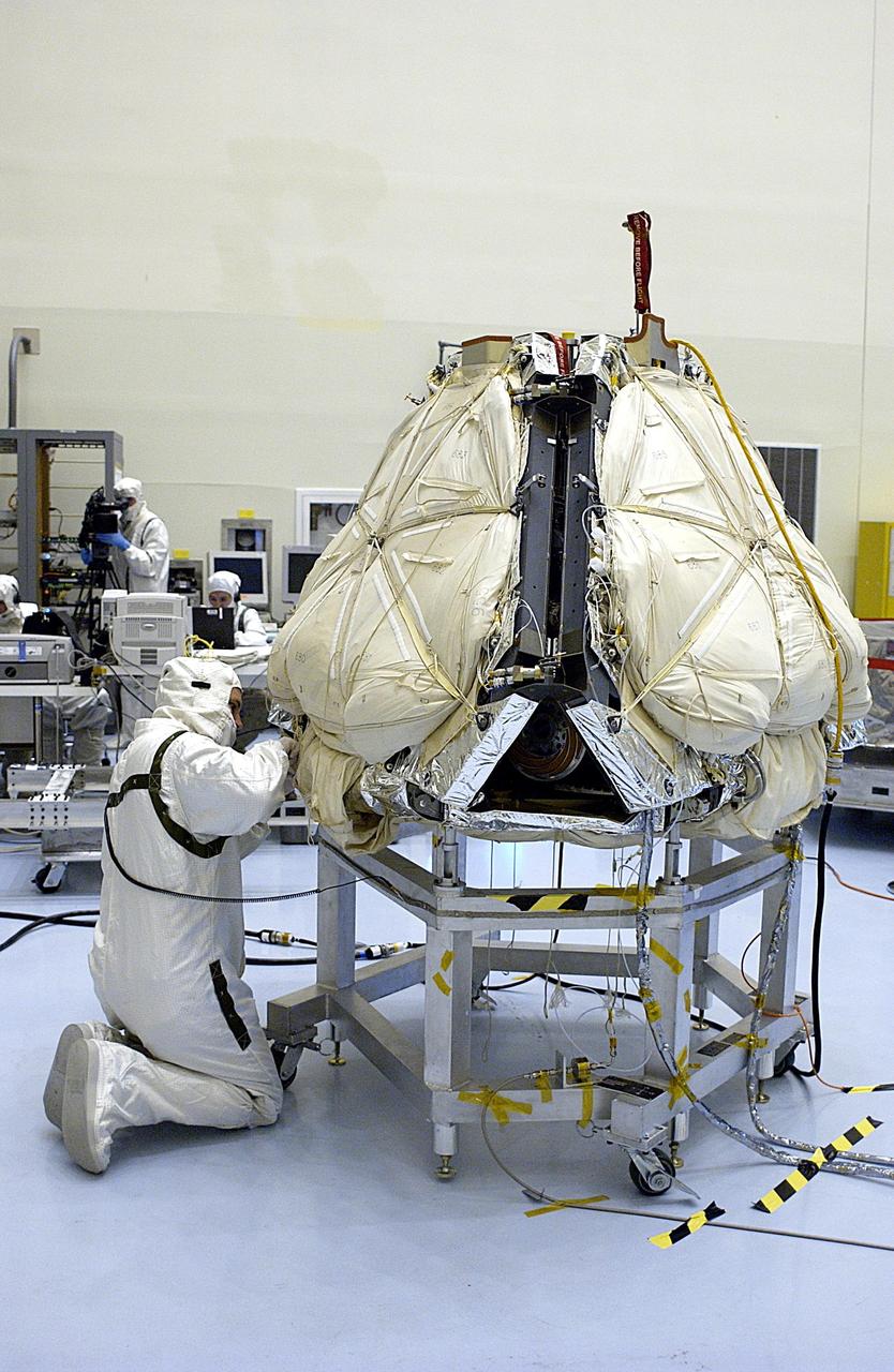 KENNEDY SPACE CENTER, FLA. -- In the Payload Hazardous Servicing Facility, a technician prepares to reopen the lander petals of the Mars Exploration Rover 2 (MER-2) to allow access to one of the spacecraft's circuit boards.  A concern arose during prelaunch testing regarding how the spacecraft interprets signals sent from its main computer to peripherals in the cruise stage, lander and small deep space transponder.  The MER Mission consists of two identical rovers set to launch in June 2003. The problem will be fixed on both rovers.