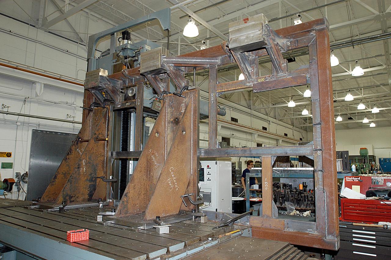 KENNEDY SPACE CENTER, FLA. -- A main landing gear door mounting fixture in the Launch Equipment Shop is being used to support the Columbia mishap investigation.  A simulated orbiter wing and several test panels, along with sections of Space Shuttle orbiter Enterprise (OV-101), will be transferred to the Southwest Research Institute for testing after Thermal Protection System (TPS) tile installation is complete. The testing has been requested by the Columbia Accident Investigation Board. For this initiative, sections of Enterprise were borrowed from the Smithsonian Institution's Air and Space Museum where the orbiter is being stored at the Washington Dulles International Airport. Enterprise was the first orbiter built in the Shuttle fleet and was used to conduct the Approach and Landing Test Program before the first powered Shuttle flight.