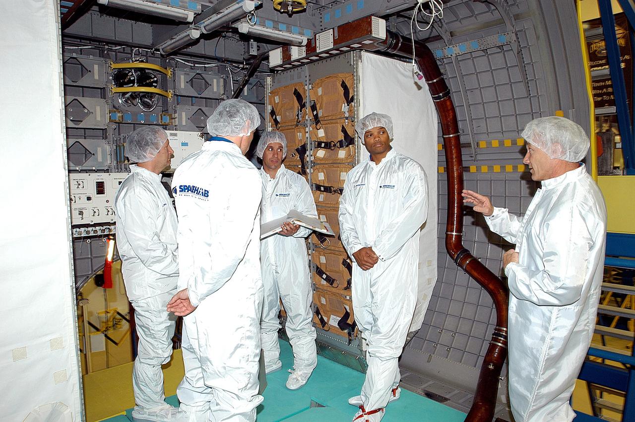 KENNEDY SPACE CENTER, FLA. - The STS-116 crew take part in training in the SPACEHAB module. From left are Mission Specialist Christer Fuglesang; a trainer; Pilot Michael Oefelein; Mission Specialist Robert Curbeam; and Commander Terrence Wilcutt. Objective of their mission to the International Space Station is to deliver and attach the third port truss segment, the P5 Truss, deactivate and retract the P6 Truss Channel 4B (port-side) solar array, and reconfigure station power from 2A and 4A solar arrays. A launch date is under review