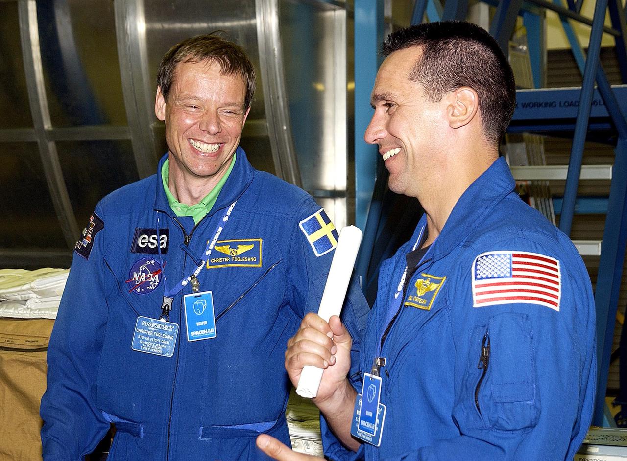 KENNEDY SPACE CENTER, FLA. - At SPACEHAB, Port Canaveral, Fla., STS-116 Mission Specialist Christer Fuglesang (left) and Pilot Michael Oelefein share a laugh during a break in training. Fuglesang is with the European Space Agency. Not seen are Commander Terrence Wilcutt and Mission Specialist Robert Curbeam. Objective of their mission to the International Space Station is to deliver and attach the third port truss segment, the P5 Truss, deactivate and retract the P6 Truss Channel 4B (port-side) solar array, and reconfigure station power from 2A and 4A solar arrays. A launch date is under review.