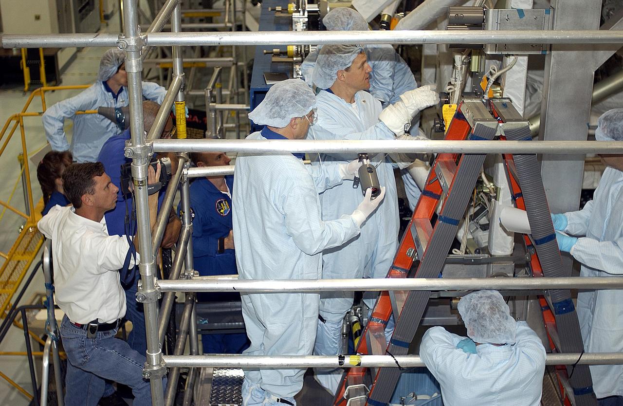 KENNEDY SPACE CENTER, FLA. - STS-118 Mission Specialists Dafydd Williams (center left) and Scott Parazynski (center right) practice using equipment during training in the Space Station Processing Facility. They and other crew members are at KSC to become familiar with equipment for their mission. The mission will be delivering the third starboard truss segment, the ITS S5, to the International Space Station, and a SPACEHAB Single Cargo Module with supplies and equipment. Launch date is under review.