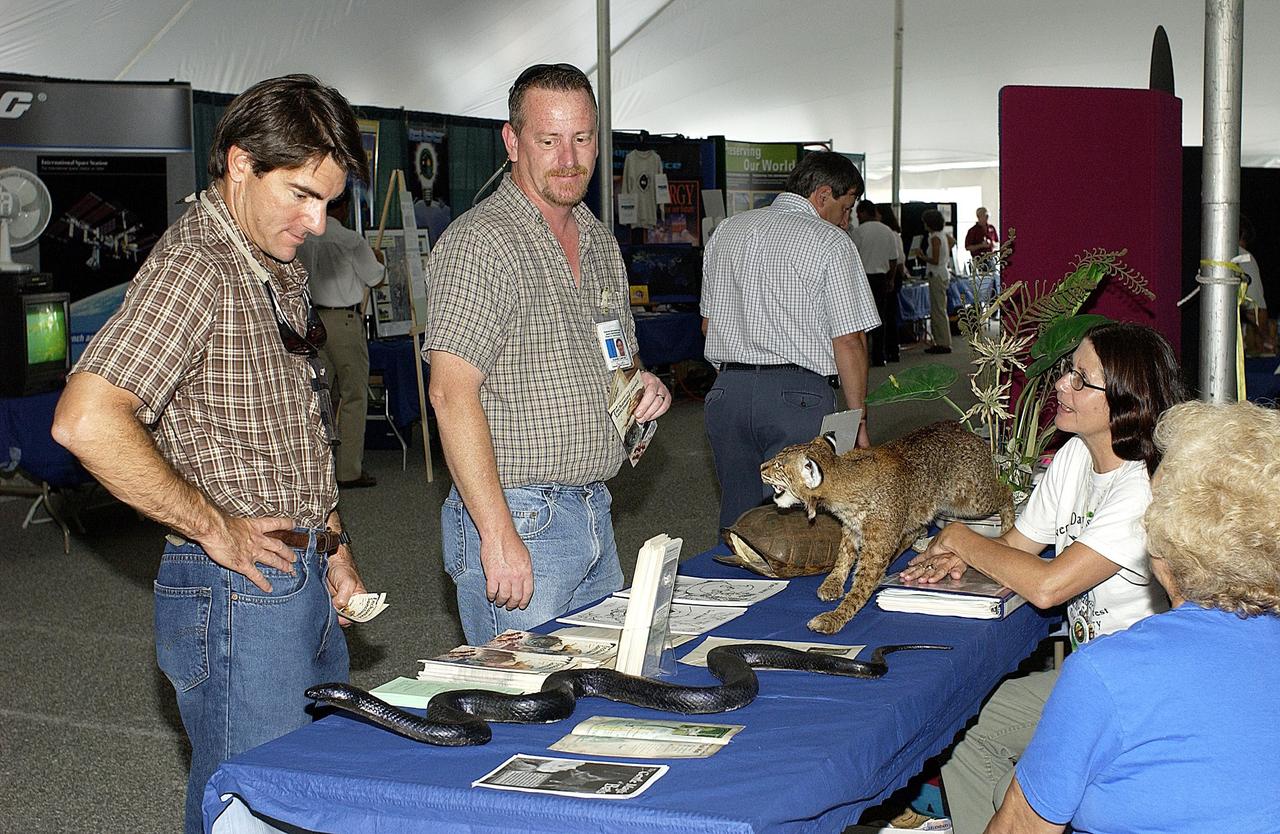 KENNEDY SPACE CENTER, FLA. - Employees stop to look at examples at the Natural Resources Booth during Energy and Awareness Week activities.  The two-day event was held April 22-23 around the Center.