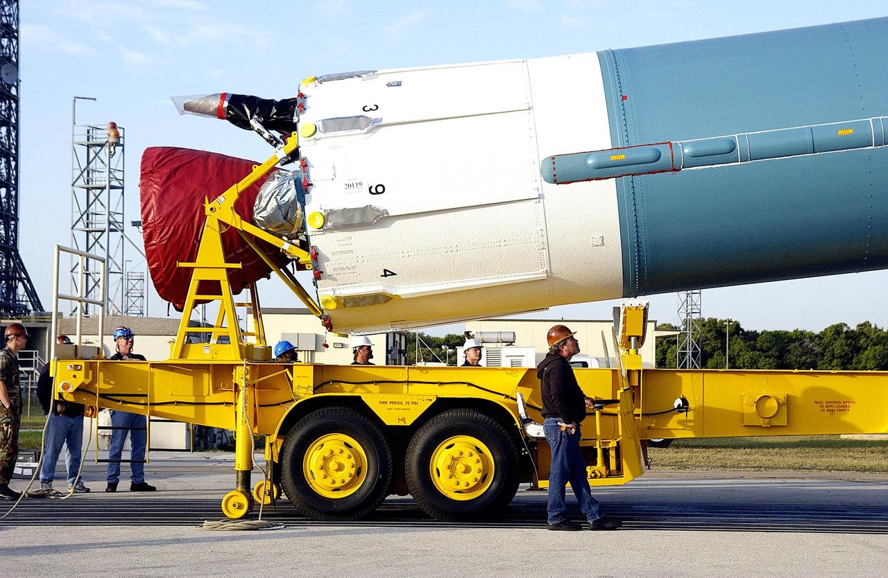 KENNEDY SPACE CENTER, FLA. -  The angle of the first stage of the Delta II rocket on its transporter indicates it is being lifted to vertical for erection on Pad 17-A on Cape Canaveral Air Force Station. The Delta will launch the Mars Exploration Rover (MER-A) vehicle.  The MER Mission consists of two identical rovers designed to cover roughly 110 yards each Martian day over various terrain. Each rover will carry five scientific instruments that will allow it to search for evidence of liquid water that may have been present in the planet's past.  Identical to each other, the rovers will land at different regions of Mars. Launch date for this first of NASA's two Mars Exploration Rover missions is scheduled no earlier than June 6.