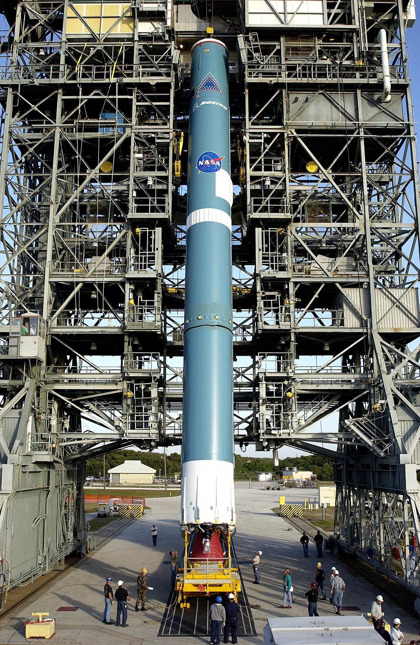KENNEDY SPACE CENTER, FLA. - On Pad 17-A, Cape Canaveral Air Force Station, the first stage of the Delta II rocket is nearly vertical in the launch tower. The Delta will launch the Mars Exploration Rover (MER-A) vehicle. The MER Mission consists of two identical rovers designed to cover roughly 110 yards each Martian day over various terrain. Each rover will carry five scientific instruments that will allow it to search for evidence of liquid water that may have been present in the planet's past.  Identical to each other, the rovers will land at different regions of Mars.  Launch date for this first of NASA's two Mars Exploration Rover missions is scheduled no earlier than June 6.