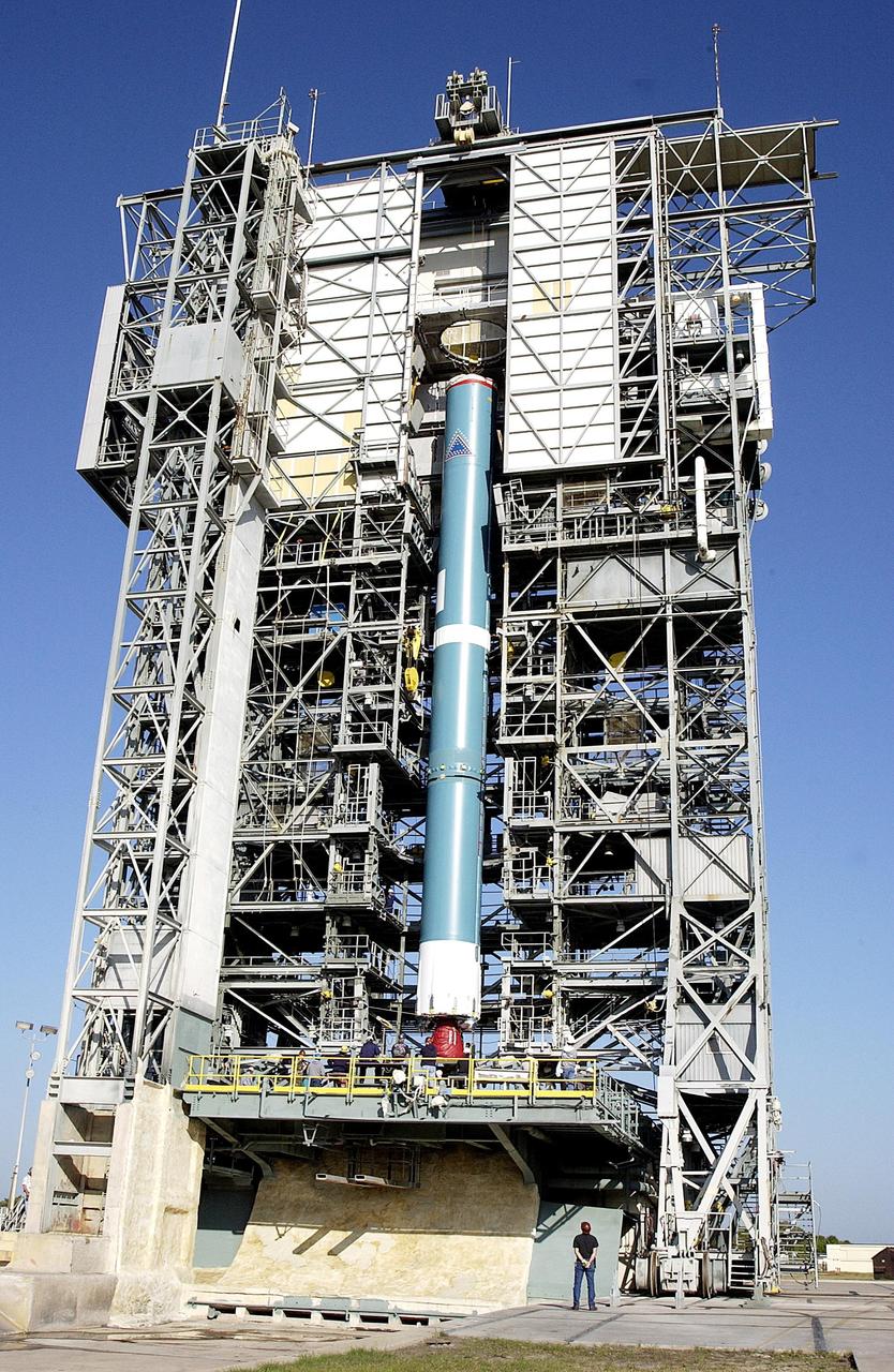 KENNEDY SPACE CENTER, FLA. - On Pad 17-A, Cape Canaveral Air Force Station, the first stage of the Delta II rocket is lifted up the launch tower. The Delta will launch the Mars Exploration Rover (MER-A) vehicle. The MER Mission consists of two identical rovers designed to cover roughly 110 yards each Martian day over various terrain. Each rover will carry five scientific instruments that will allow it to search for evidence of liquid water that may have been present in the planet's past.  Identical to each other, the rovers will land at different regions of Mars.  Launch date for this first of NASA's two Mars Exploration Rover missions is scheduled no earlier than June 6.