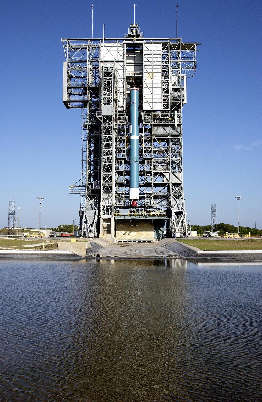 KENNEDY SPACE CENTER, FLA. - On Pad 17-A, Cape Canaveral Air Force Station, the first stage of the Delta II rocket is lifted up the launch tower. The Delta will launch the Mars Exploration Rover (MER-A) vehicle. The MER Mission consists of two identical rovers designed to cover roughly 110 yards each Martian day over various terrain. Each rover will carry five scientific instruments that will allow it to search for evidence of liquid water that may have been present in the planet's past.  Identical to each other, the rovers will land at different regions of Mars.  Launch date for this first of NASA's two Mars Exploration Rover missions is scheduled no earlier than June 6.