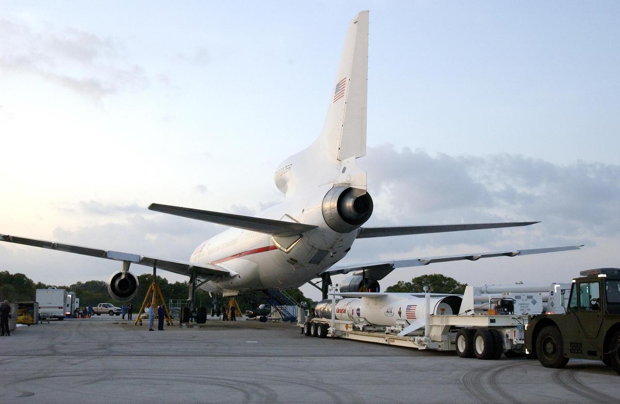 KENNEDY SPACE CENTER, FLA. -  In the early morning light, the mated Pegasus XL and Galaxy Evolution Explorer (GALEX) satellite are seen near the Orbital Sciences L-1011 aircraft at Cape Canaveral Air Force Station.  The GALEX, to be launched April 28 from the L-1011, will carry into space an orbiting telescope that will observe a million galaxies across 10 billion years of cosmic history to help astronomers determine when the stars and elements we see today had their origins. The spacecraft will sweep the skies for 28 months using state-of-the-art ultraviolet detectors to single out galaxies dominated by young, hot, short-lived stars that give off a great deal of energy at that wavelength.  These galaxies are actively creating stars, and therefore provide a window into the history and causes of star formation in galaxies.