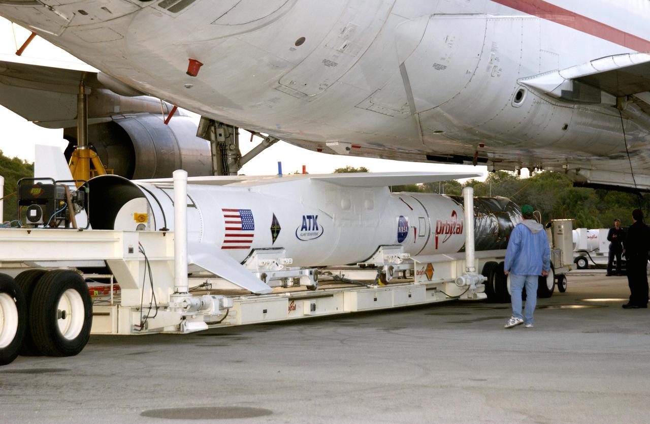 KENNEDY SPACE CENTER, FLA. - The mated Pegasus XL and Galaxy Evolution Explorer (GALEX) satellite move under the Orbital Sciences L-1011 aircraft at Cape Canaveral Air Force Station.  The GALEX, to be launched April 28 from the L-1011, will carry into space an orbiting telescope that will observe a million galaxies across 10 billion years of cosmic history to help astronomers determine when the stars and elements we see today had their origins. The spacecraft will sweep the skies for 28 months using state-of-the-art ultraviolet detectors to single out galaxies dominated by young, hot, short-lived stars that give off a great deal of energy at that wavelength.  These galaxies are actively creating stars, and therefore provide a window into the history and causes of star formation in galaxies.