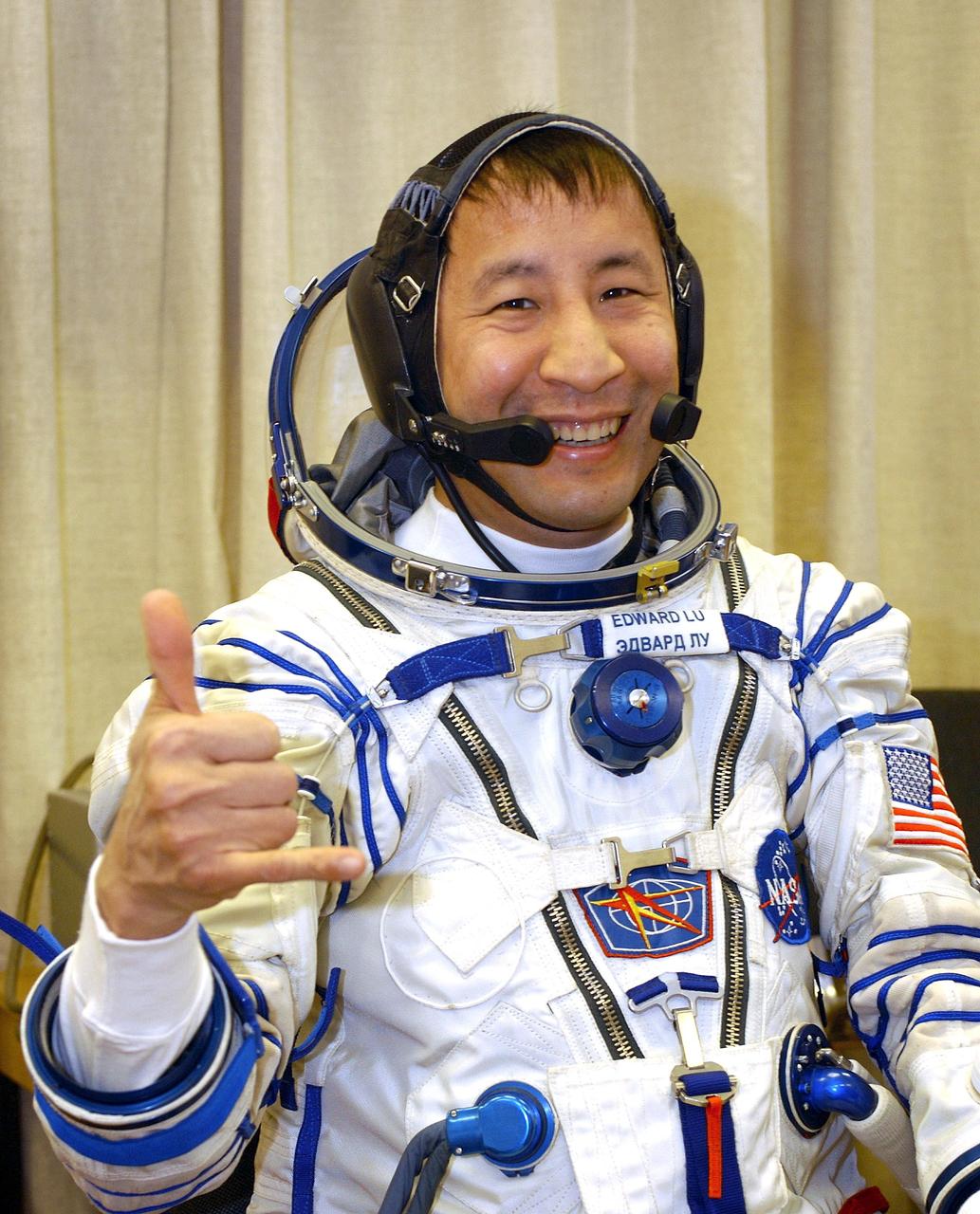 Baikonur Cosmodrome, Kazakhstan -- Astronaut Edward T. Lu, NASA ISS science officer and flight engineer for Expedition Seven dons his Russian Sokol suit for the leak check and Soyuz inspection, seat liner check.  Veteran Russian cosmonaut Yuri Malenchenko and veteran NASA astronaut Ed Lu have been named as the primary crew for the planned April 26, 2003, launch of a Russian Soyuz TMA-2 spacecraft to the International Space Station. Malenchenko and Lu will be called the Expedition 7 crew. Russian cosmonaut Alexander Kaleri and NASA astronaut Michael Foale are the backup crewmembers to Malenchenko and Lu.  Expedition 6 Commander Ken Bowersox, Flight Engineer Nikolai Budarin and NASA Space Station Science Officer Don Pettit will return to Earth aboard the Soyuz TMA-1 craft in May 2003. The three Expedition 6 crewmembers were launched on Nov. 23, 2002. They have been aboard the Station since November 25. They were originally scheduled to return in March aboard the Space Shuttle Atlantis during the STS-114 mission.  Malenchenko and Lu will continue to operate the science payloads already on board, as well as maintaining the Station.  Photo Credit: NASA/Bill Ingalls