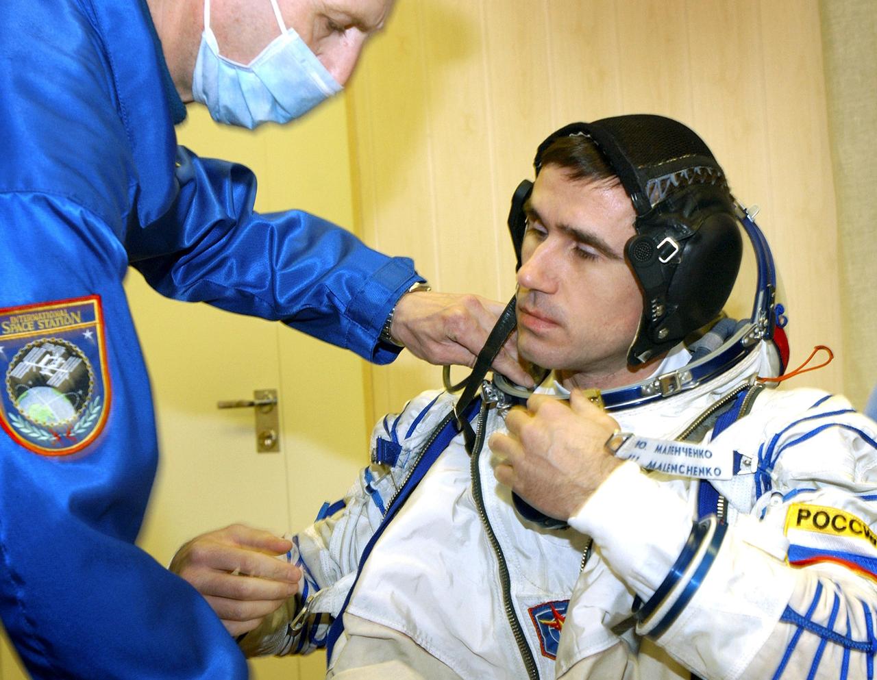 Baikonur Cosmodrome, Kazakhstan -- Cosmonaut Yuri I. Malenchenko, Expedition Seven commander dons his Russian Sokol suit for the leak check and Soyuz inspection, seat liner check. Veteran Russian cosmonaut Yuri Malenchenko and veteran NASA astronaut Ed Lu have been named as the primary crew for the planned April 26, 2003, launch of a Russian Soyuz TMA-2 spacecraft to the International Space Station. Malenchenko and Lu will be called the Expedition 7 crew. Russian cosmonaut Alexander Kaleri and NASA astronaut Michael Foale are the backup crewmembers to Malenchenko and Lu. Expedition 6 Commander Ken Bowersox, Flight Engineer Nikolai Budarin and NASA Space Station Science Officer Don Pettit will return to Earth aboard the Soyuz TMA-1 craft in May 2003. The three Expedition 6 crewmembers were launched on Nov. 23, 2002. They have been aboard the Station since November 25. They were originally scheduled to return in March aboard the Space Shuttle Atlantis during the STS-114 mission. Malenchenko and Lu will continue to operate the science payloads already on board, as well as maintaining the Station. Photo Credit: NASA/Bill Ingalls