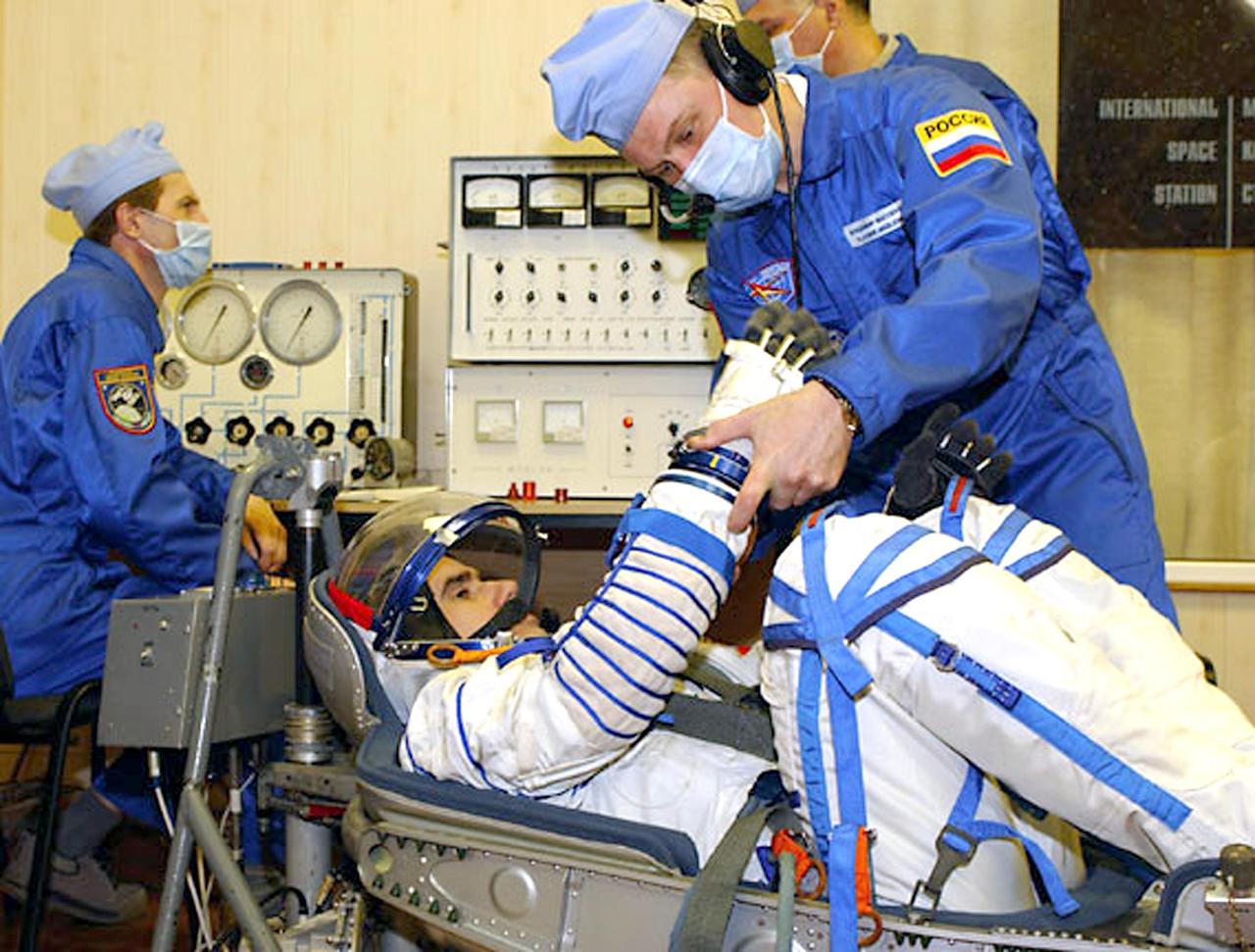 Baikonur Cosmodrome, Kazakhstan -- Building 254, Soyuz Integration Facility. Veteran Russian Cosmonaut Yuri Malenchenko has a leak check performed on the Russian Sokol suit.  Malenchenko and veteran NASA astronaut Ed Lu were named as the primary crew, Expedition 7, for the launch to the International Space Station. Russian cosmonaut Alexander Kaleri and NASA astronaut Michael Foale are the backup crewmembers to Malenchenko and Lu.  Expedition 6 Commander Ken Bowersox, Flight Engineer Nikolai Budarin and NASA Space Station Science Officer Don Pettit will return to Earth aboard the Soyuz TMA-1 craft in May 2003. The three Expedition 6 crewmembers were launched on Nov. 23, 2002. They have been aboard the Station since November 25. They were originally scheduled to return in March aboard the Space Shuttle Atlantis during the STS-114 mission.  Malenchenko and Lu will continue to operate the science payloads already on board, as well as maintaining the Station.  Photo Credit: NASA/Bill Ingalls