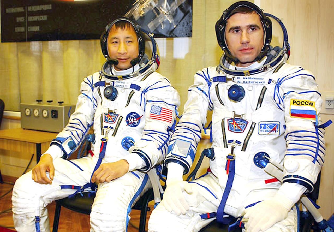 Baikonur Cosmodrome, Kazakhstan -- Building 254, Soyuz Integration Facility.  Cosmonaut Yuri I. Malenchenko (right), Expedition Seven commander, and astronaut Edward T. Lu, NASA ISS science officer and flight engineer for Expedition Seven, pause for a photograph after the Soyuz inspection, seat liner check. Malenchenko and Lu were named as the primary crew, Expedition 7, for the launch to the International Space Station. Russian cosmonaut Alexander Kaleri and NASA astronaut Michael Foale are the backup crewmembers to Malenchenko and Lu.  Expedition 6 Commander Ken Bowersox, Flight Engineer Nikolai Budarin and NASA Space Station Science Officer Don Pettit will return to Earth aboard the Soyuz TMA-1 craft in May 2003. The three Expedition 6 crewmembers were launched on Nov. 23, 2002. They have been aboard the Station since November 25. They were originally scheduled to return in March aboard the Space Shuttle Atlantis during the STS-114 mission.  Malenchenko and Lu will continue to operate the science payloads already on board, as well as maintaining the Station.  Photo Credit: NASA/Bill Ingalls