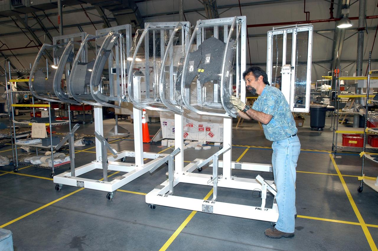 KENNEDY SPACE CENTER, FLA. - In the RLV Hangar, a member of the Columbia Reconstruction Project Team examines debris from Columbia.  More than 70,000 items have been delivered to KSC for use in the mishap  investigation.