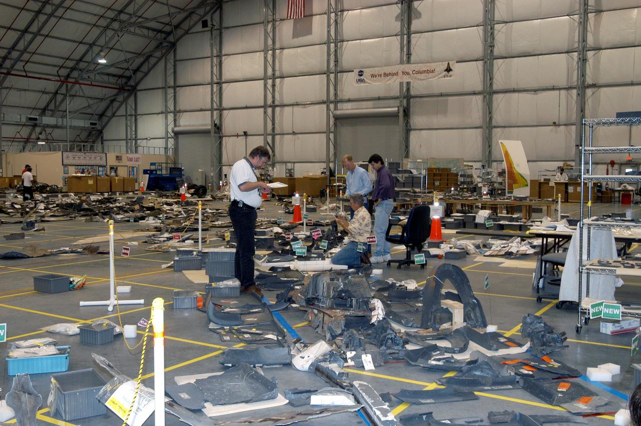 KENNEDY SPACE CENTER, FLA. - In the RLV Hangar, several pieces of debris from Columbia are being examined.  More than 70,000 items have been delivered to KSC for use in the mishap investigation.  A portion of them sit on the floor within the grid and outline of Columbia.