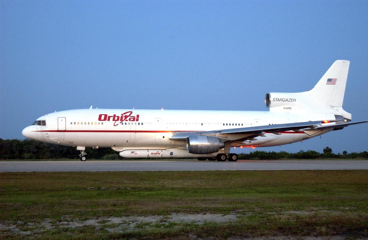 KENNEDY SPACE CENTER, FLA. - At Cape Canaveral Air Force Station, Orbital Sciences' L-1011 aircraft waits for takeoff time between 7:50 and 9:50 a.m. EDT.  Attached underneath is the Pegasus XL rocket with its payload, the Galaxy Evolution Explorer (GALEX), due to be released about 8 a.m.  The GALEX will carry into space an orbiting telescope that will observe a million galaxies across 10 billion years of cosmic history to help astronomers determine when the stars and elements we see today had their origins. The spacecraft will sweep the skies for 28 months using state-of-the-art ultraviolet detectors to single out galaxies dominated by young, hot, short-lived stars that give off a great deal of energy at that wavelength.  These galaxies are actively creating stars, and therefore provide a window into the history and causes of star formation in galaxies.