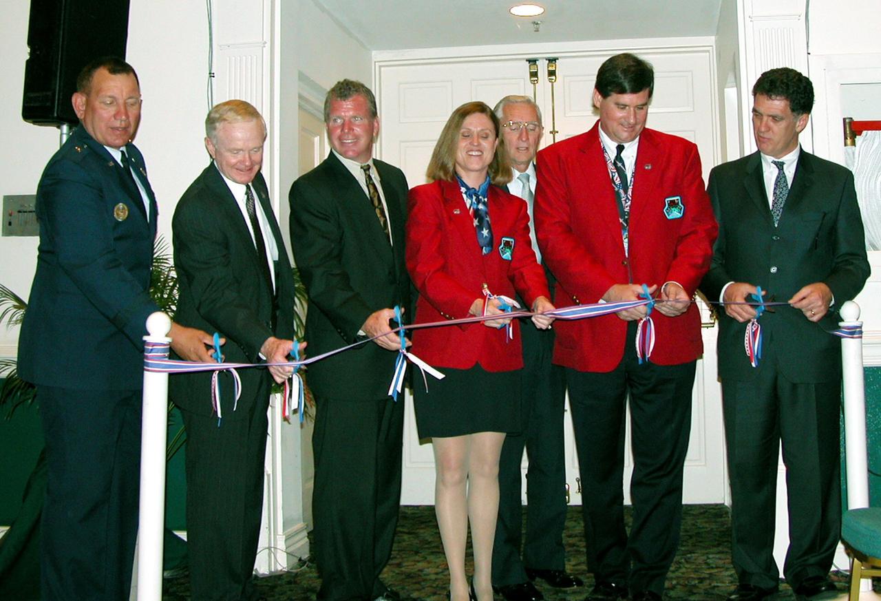 KENNEDY SPACE CENTER, FLA. -  Cutting the exhibitors ribbon for the opening of the 40th Space Congress, held April 28-May 1, 2003, in Cape Canaveral, Fla., are (left to right), Brig. Gen. J. Gregory Pavlovich, commander, 45th Space Wing; Center Director Roy Bridges Jr.; U.S. Representative Tom Feeney; Vice Chair of the Space Congress Committee Rita Willcoxon; Mayor of Cape Canaveral Rocky Randels; General Chair of the Space Congress Committee Kevin Hoshstrasser; and U.S. Representative Dave Weldon.  The Space Congress is an international conference that gathers attendees from the scientific community, the space industry workforce, educators and local supporting industries.  This year's event commemorated the 40th anniversary of the Kennedy Space Center and the Centennial of Flight.  The theme for the Space Congress was "Linking the Past to the Future: A Celebration of Space."