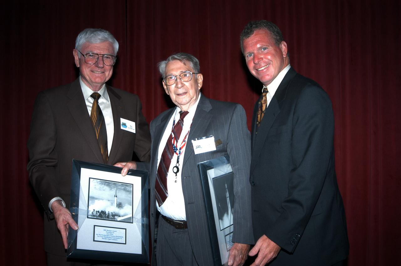 KENNEDY SPACE CENTER, FLA. - Bud Gardner (left), with the Florida Space Research Institute, and U.S. Representative Tom Feeney (right) pose with John Winn, who received the 2003 Bumper award at the Congressional Dinner for outstanding contributions to Florida’s space industry. The award was presented by the Florida Space Business Roundtable. The dinner kicked off the annual Space Congress, held April 28-May 1, 2003, in Cape Canaveral, Fla. The theme for the event was “Linking the Past to the Future: A Celebration of Space” and commemorated the 40th anniversary of the Kennedy Space Center and the Centennial of Flight.