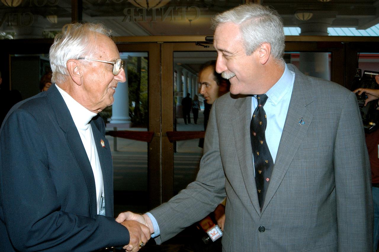 KENNEDY SPACE CENTER, FLA. - Gunther Wendt (left), NASA retiree, shakes hands with NASA Administrator Sean O'Keefe during the annual Congressional Dinner hosted by the Florida Space Business Roundtable.  The dinner kicked off the annual Space Congress, held April 28-May 1, 2003, in Cape Canaveral, Fla.  The theme for the event was "Linking the Past to the Future: A Celebration of Space" and commemorated the 40th anniversary of the Kennedy Space Center and the Centennial of Flight.