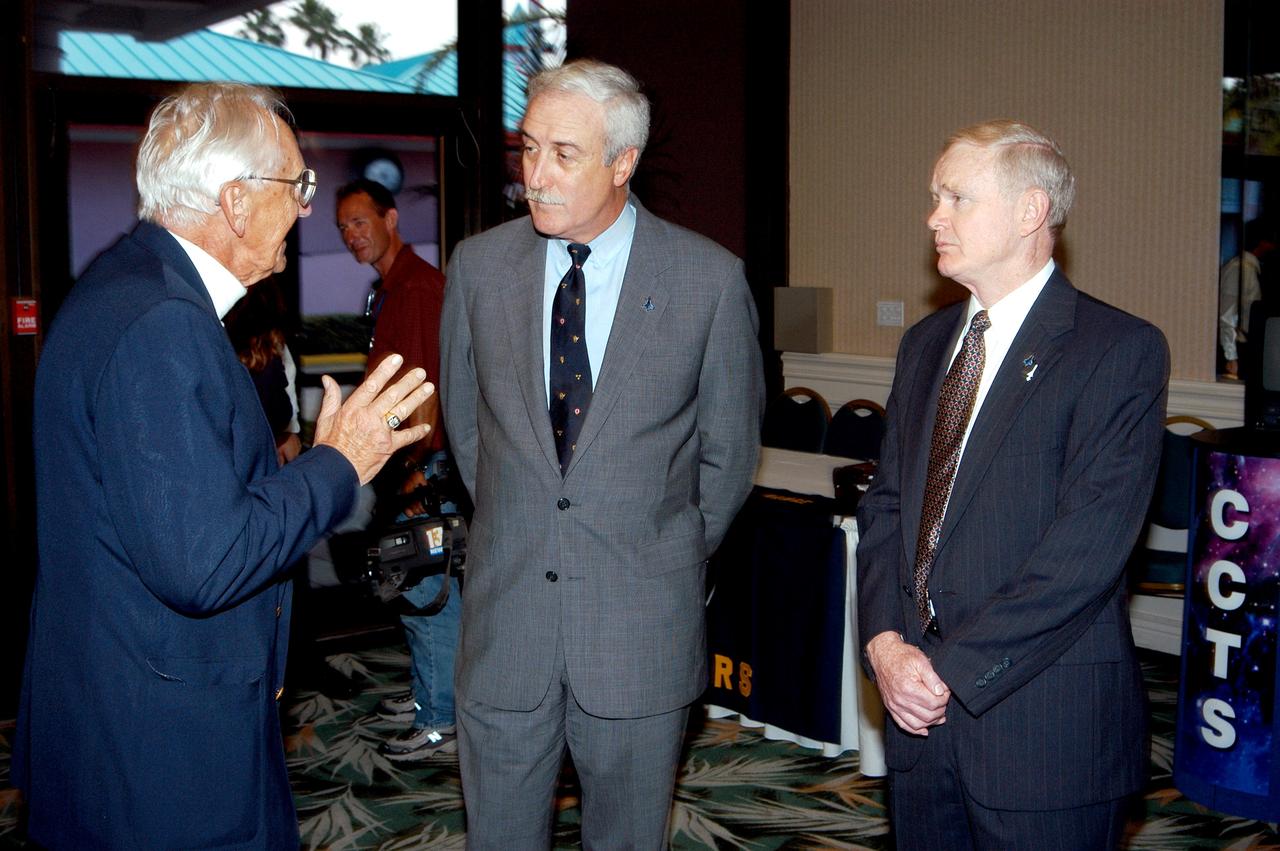 KENNEDY SPACE CENTER, FLA. - Gunther Wendt (left), NASA retiree, holds the attention of NASA Administrator Sean O'Keefe (center) and Center Director Roy Bridges Jr. (right) at the annual Congressional Dinner hosted by the Florida Space Business Roundtable.  The dinner kicked off the annual Space Congress, held April 28-May 1, 2003, in Cape Canaveral, Fla.  The theme for the event was "Linking the Past to the Future: A Celebration of Space" and commemorated the 40th anniversary of the Kennedy Space Center and the Centennial of Flight.