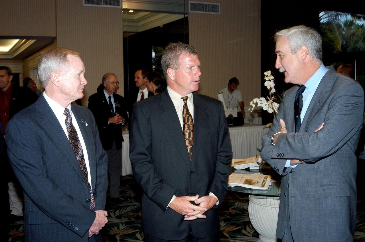 KENNEDY SPACE CENTER, FLA. -  During the annual Congressional Dinner hosted by the Florida Space Business Roundtable, Center Director Roy Bridges Jr. (left), U.S. Representative Tom Feeney (center) talk with NASA Administrator Sean O'Keefe (right).   Feeney addressed dinner guests about space, military and defense policy issues under consideration in Washington. The dinner kicked off the annual Space Congress, held April 28-May 1, 2003, in Cape Canaveral, Fla.  The theme for the event was "Linking the Past to the Future: A Celebration of Space" and commemorated the 40th anniversary of the Kennedy Space Center and the Centennial of Flight.