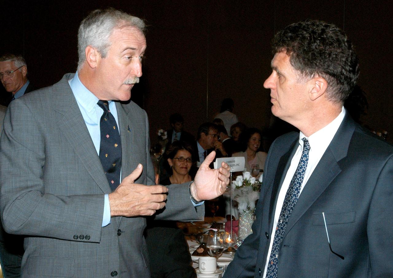 KENNEDY SPACE CENTER, FLA. - During the annual Congressional Dinner hosted by the Florida Space Business Roundtable, NASA Administrator Sean O'Keefe (left) talks with U.S. Representative Dave Weldon. The congressman addressed dinner guests about space, military and defense policy issues under consideration in Washington. The dinner kicked off the annual Space Congress, held April 28-May 1, 2003, in Cape Canaveral, Fla. The theme for the event was "Linking the Past to the Future: A Celebration of Space" and commemorated the 40th anniversary of the Kennedy Space Center and the Centennial of Flight.