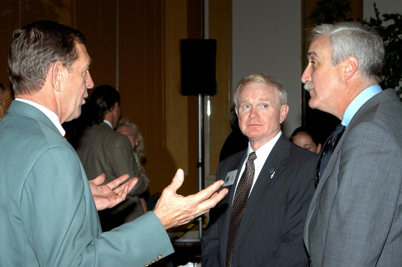 KENNEDY SPACE CENTER, FLA. - Mike McCulley (left), chief operating officer with United Space Alliance, talks with Center Director Roy Bridges Jr. (center) and NASA Administrator Sean O'Keefe (right) during the annual Congressional Dinner hosted by the Florida Space Business Roundtable.   The dinner kicked off the annual Space Congress, held April 28-May 1, 2003, in Cape Canaveral, Fla.  The theme for the event was "Linking the Past to the Future: A Celebration of Space" and commemorated the 40th anniversary of the Kennedy Space Center and the Centennial of Flight.