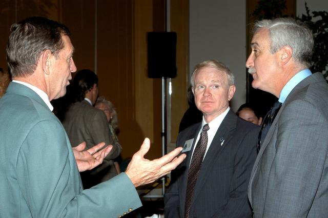 NASA image: KENNEDY SPACE CENTER, FLA. - Mike McCulley (left), chief operating officer with United Space Alliance, talks with Center Director Roy Bridges Jr. (center) and NASA Administrator Sean O'Keefe (right) during the annual Congressional Dinner hosted by the Florida Space Business Roundtable.   The dinner kicked off the annual Space Congress, held April 28-May 1, 2003, in Cape Canaveral, Fla.  The theme for the event was "Linking the Past to the Future: A Celebration of Space" and commemorated the 40th anniversary of the Kennedy Space Center and the Centennial of Flight.