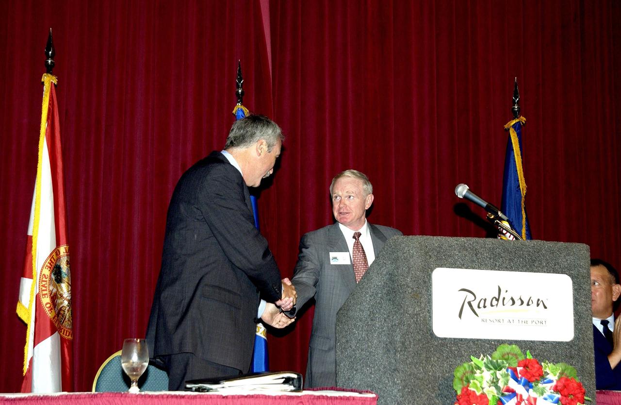 KENNEDY SPACE CENTER, FLA. - During the annual Congressional Dinner hosted by the Florida Space Business Roundtable, Center Director Roy Bridges Jr. introduces the keynote speaker, NASA Administrator Sean O'Keefe.  Held April 28-May 1, 2003, in Cape Canaveral, Fla., the event commemorated the 40th anniversary of the Kennedy Space Center and the Centennial of Flight.  The theme for the Space Congress was "Linking the Past to the Future: A Celebration of Space."  The international conference gathers attendees from the scientific community, the space industry workforce, educators and local supporting industries.