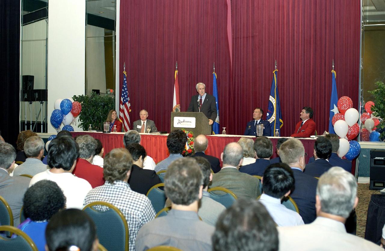 KENNEDY SPACE CENTER, FLA. - NASA Administrator Sean O'Keefe presents a framed photo to Kevin Hoshstrasser, chairman of the 40th Space Congress held April 28-May 1, 2003, in Cape Canaveral, Fla. The international conference gathers attendees from the scientific community, the space industry workforce, educators and local supporting industries. This year's event commemorated the 40th anniversary of the Kennedy Space Center and the Centennial of Flight. The theme for the Space Congress was "Linking the Past to the Future: A Celebration of Space."