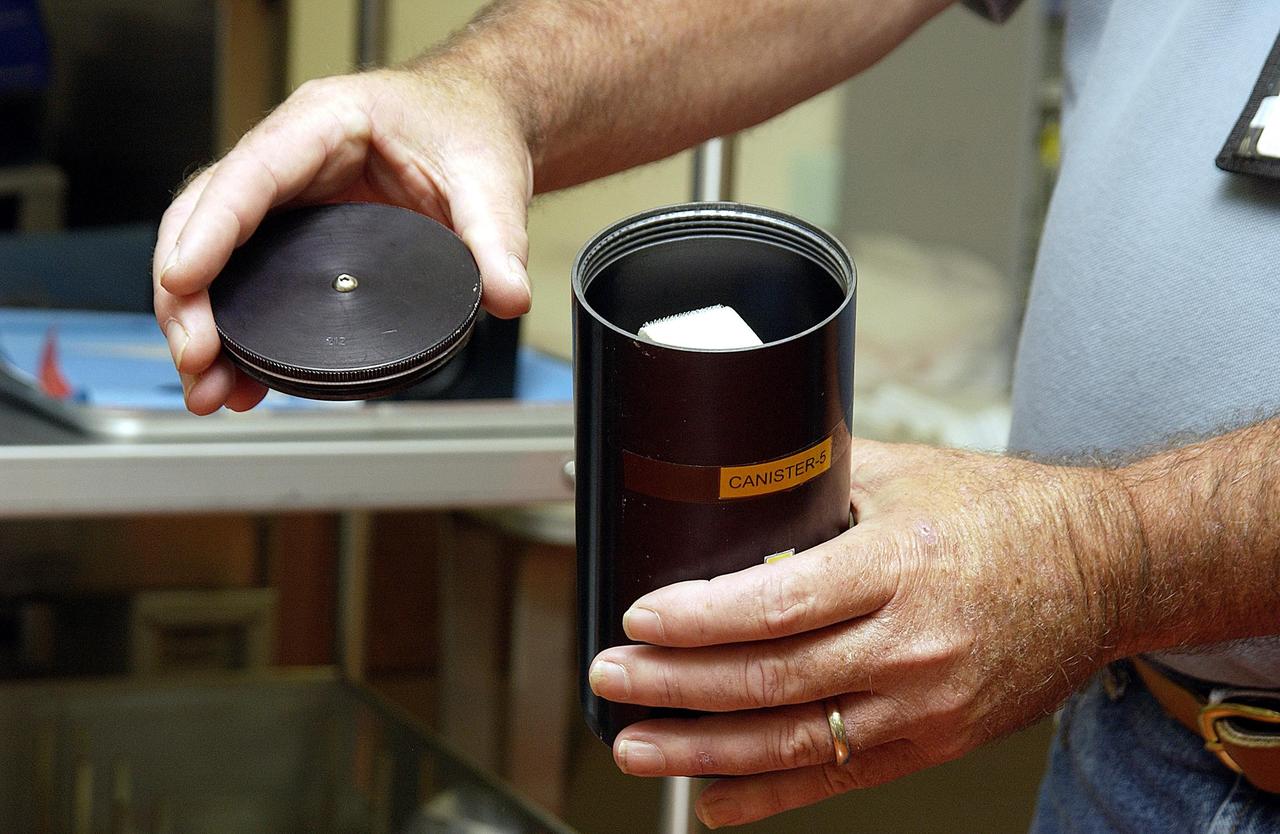 KENNEDY SPACE CENTER, FLA. - NASA Project Manager Fred Ahmay holds a Biological Research in Canisters (BRIC) container in which C. elegans nemotodes (round worms) were found. The container was part of a middeck experiment that was among the Columbia debris recovered in East Texas. The worms are descendants of those that were part of an experiment that flew on Columbia's last mission, STS-107. The experiment was designed to verify a new synthetic nutrient solution for an International Space Station (ISS) "model" specimen planned to be used extensively for ISS gene expression studies and was sponsored by the NASA Ames Research Center. Scientists are now looking over the experiment at KSC to determine if it will yield any scientific results. The investigation into the cause of the Columbia accident is ongoing.