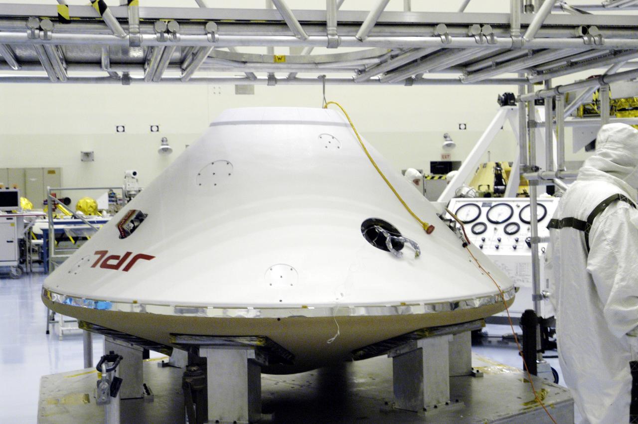 KENNEDY SPACE CENTER, FLA. -  The aeroshell enclosing Mars Exploration Rover 2 and lander rests on a stand in the Payload Hazardous Servicing Facility.  The aeroshell will undergo a spin stabilization test.  There are two identical rovers that will land at different regions of Mars and are designed to cover roughly 110 yards each Martian day over various terrain. Each rover will carry five scientific instruments that will allow it to search for evidence of liquid water that may have been present in the planet’s past.  The first rover, MER-A, is scheduled to launch June 5 from Cape Canaveral Air Force Station.  The second is scheduled for launch June 25.