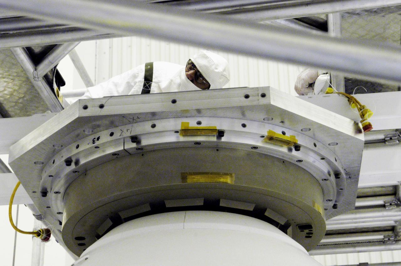 KENNEDY SPACE CENTER, FLA. - Workers in the Payload Hazardous Servicing Facility look over the aeroshell enclosing Mars Exploration Rover 2 and lander that is being moved to a rotation table for a spin stabilization test.  There are two identical rovers that will land at different regions of Mars and are designed to cover roughly 110 yards each Martian day over various terrain. Each rover will carry five scientific instruments that will allow it to search for evidence of liquid water that may have been present in the planet's past.  The first rover, MER-A, is scheduled to launch June 5 from Cape Canaveral Air Force Station.  The second is scheduled for launch June 25.