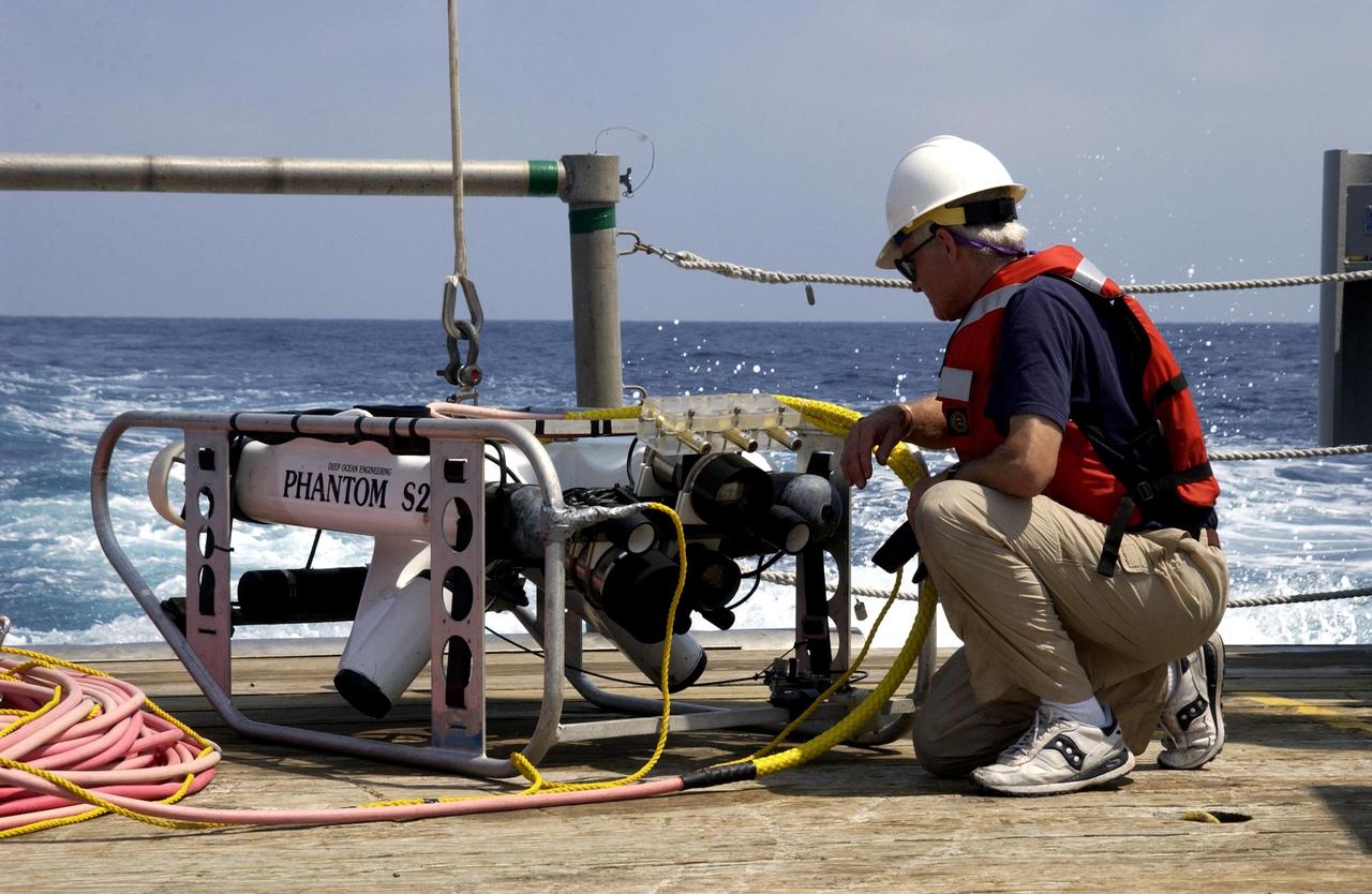 KENNEDY SPACE CENTER, FLA. -  Underwater research equipment is prepared for immersion from the Liberty Star,  the NASA Space Shuttle support ship operated by United Space Alliance.   It is being used on an undersea expedition to characterize the condition of the deep-sea coral reefs and reef fish populations in the Oculina Banks, a marine protected area, 20 miles offshore of the east coast of Florida.  The equipment includes an underwater robot, a seafloor sampler, and the Passive Acoustic Monitoring System (PAMS), originally developed by NASA to monitor the impact of rocket launches on wildlife refuge lagoons at KSC.   The research is sponsored by NOAA Fisheries.  The ship departed from Port Canaveral April 29 and will return May 9.