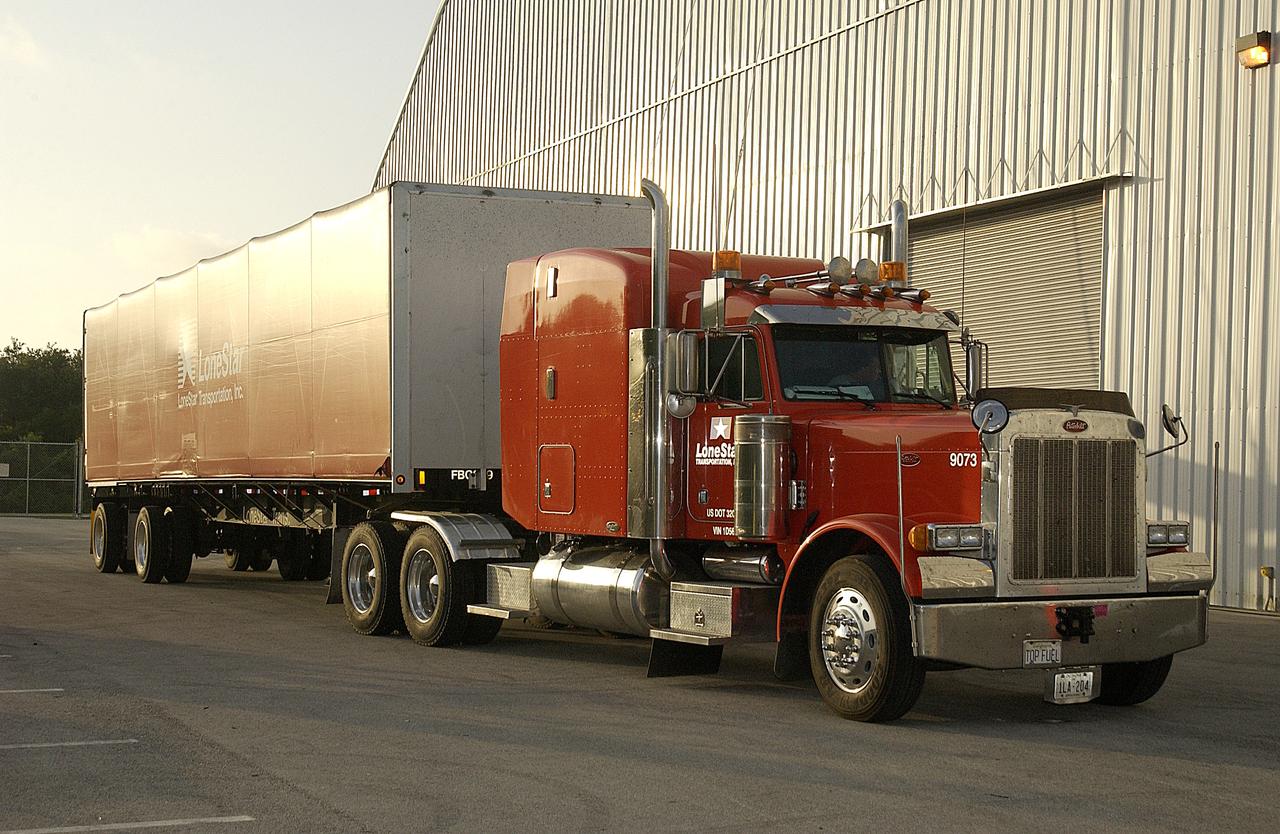 The truck holding the final shipment of Columbia debris arrives at KSC. The recovery efforts have been concluded in East Texas. Prior to this final shipment, the total number of items at KSC is 82,567, weighing 84,800 pounds or 38 percent of the total dry weight of Columbia. Of those items, 78,760 have been identified, with 753 placed on the left wing grid in the RLV Hangar. 