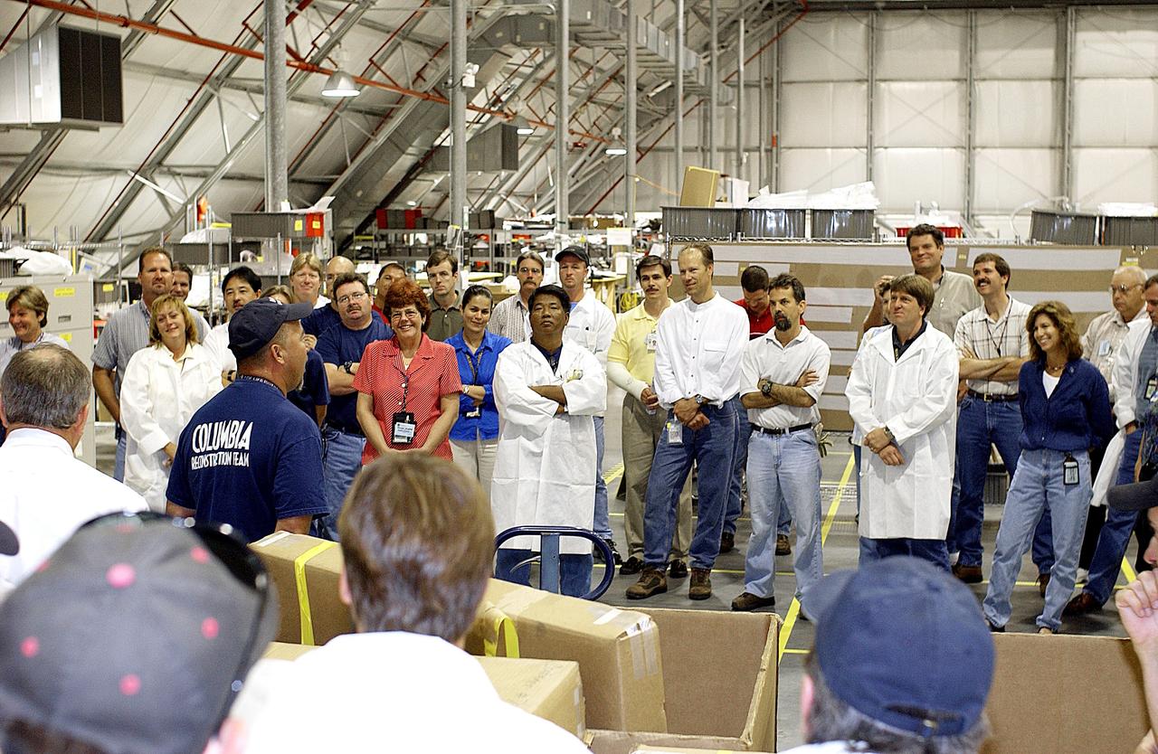 KENNEDY SPACE CENTER, FLA. - The Columbia Reconstruction Project team meets before arrival of the final shipment of Columbia debris.  The recovery efforts have been concluded in East Texas.  Prior to this final shipment, the total number of items at KSC is 82,567, weighing 84,800 pounds or 38 percent of the total dry weight of Columbia.  Of those items, 78,760 have been identified, with 753 placed on the left wing grid in the RLV Hangar.