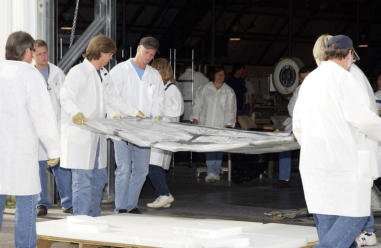 KENNEDY SPACE CENTER, FLA. -  Part of the final shipment of Columbia debris is transferred into the RLV Hangar at KSC.  The recovery efforts have been concluded in East Texas.  Prior to this final shipment, the total number of items at KSC is 82,567, weighing 84,800 pounds or 38 percent of the total dry weight of Columbia.  Of those items, 78,760 have been identified, with 753 placed on the left wing grid in the RLV Hangar.