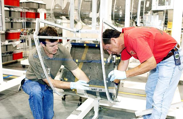 NASA image: KENNEDY SPACE CENTER, FLA. -  Members of the Columbia Reconstruction Project Team place debris on the mounting fixture for RCC pieces of the leading edge of Columbia’s left wing.   The final shipment of debris arrived on this date - recovery efforts have been concluded in East Texas.  Prior to this final shipment, the total number of items at KSC is 82,567, weighing 84,800 pounds or 38 percent of the total dry weight of Columbia.  Of those items, 78,760 have been identified, with 753 placed on the left wing grid in the RLV Hangar.