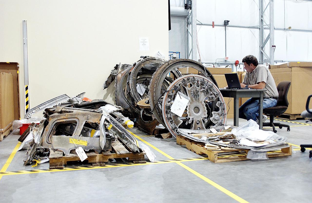 KENNEDY SPACE CENTER, FLA. - Large pieces of Columbia debris are stacked along a wall in the RLV Hangar at KSC.  The final shipment of debris arrived on this date - recovery efforts have been concluded in East Texas.  Prior to this final shipment, the total number of items at KSC is 82,567, weighing 84,800 pounds or 38 percent of the total dry weight of Columbia.  Of those items, 78,760 have been identified, with 753 placed on the left wing grid in the RLV Hangar.