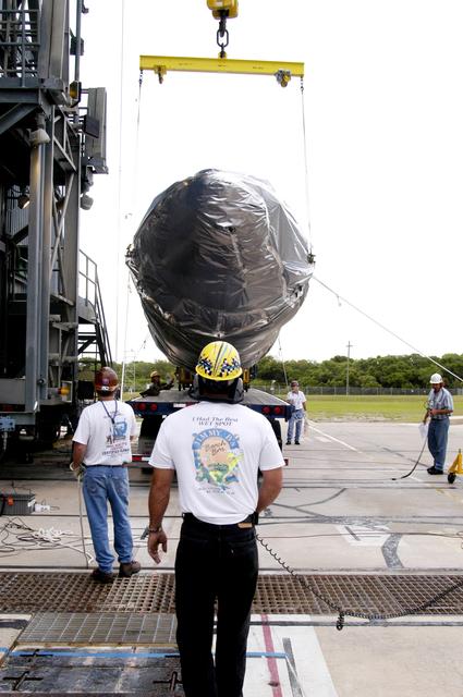 NASA image: KENNEDY SPACE CENTER, FLA. - At Launch Complex 17-A, Cape Canaveral Air Force Station, a crane is in place to lift the fairing for the Mars Exploration Rover 2 (MER-2/MER-A).  The fairing will be installed around the payload for protection during launch.  The MER Mission consists of two identical rovers designed to cover roughly 110 yards each Martian day over various terrain. Each rover will carry five scientific instruments that will allow it to search for evidence of liquid water that may have been present in the planet's past.  Identical to each other, the rovers will land at different regions of Mars.  Launch date for MER-A  is scheduled for June 5.
