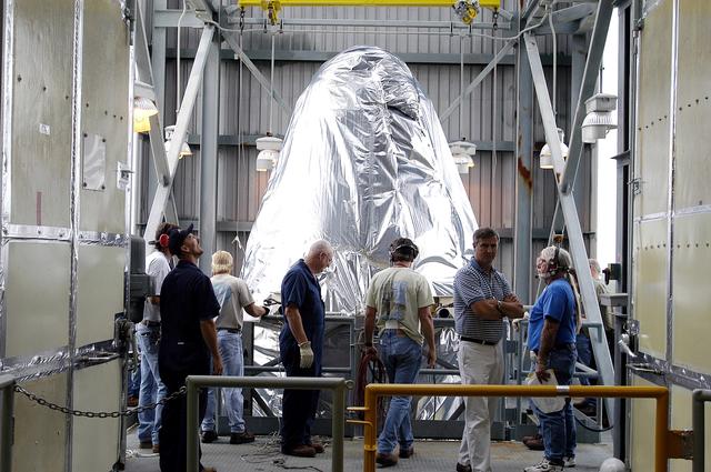 NASA image: KENNEDY SPACE CENTER, FLA. - At Launch Complex 17-A, Cape Canaveral Air Force Station, the first half of the fairing for the Mars Exploration Rover 2 (MER-2/MER-A) reaches the top of the launch tower.  The fairing will be installed around the payload for protection during launch.  The MER Mission consists of two identical rovers designed to cover roughly 110 yards each Martian day over various terrain. Each rover will carry five scientific instruments that will allow it to search for evidence of liquid water that may have been present in the planet's past.  Identical to each other, the rovers will land at different regions of Mars.  Launch date for MER-A  is scheduled for June 5.