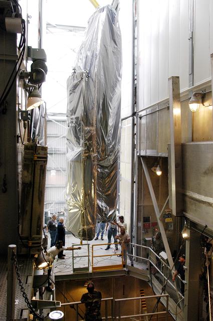 NASA image: KENNEDY SPACE CENTER, FLA. - At Launch Complex 17-A, Cape Canaveral Air Force Station, the first half of the fairing for the Mars Exploration Rover 2 (MER-2/MER-A) is moved inside the launch tower.  The fairing will be installed around the payload for protection during launch.  The MER Mission consists of two identical rovers designed to cover roughly 110 yards each Martian day over various terrain. Each rover will carry five scientific instruments that will allow it to search for evidence of liquid water that may have been present in the planet's past.  Identical to each other, the rovers will land at different regions of Mars.  Launch date for MER-A  is scheduled for June 5..