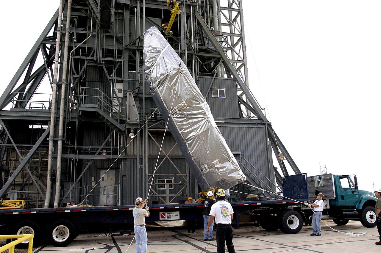KENNEDY SPACE CENTER, FLA. - At Launch Complex 17-A, Cape Canaveral Air Force Station, the second half of the fairing for the Mars Exploration Rover 2 (MER-2/MER-A) is raised to a vertical position for its lift up the launch tower.  The fairing will be installed around the payload for protection during launch.  The MER Mission consists of two identical rovers designed to cover roughly 110 yards each Martian day over various terrain. Each rover will carry five scientific instruments that will allow it to search for evidence of liquid water that may have been present in the planet's past.  Identical to each other, the rovers will land at different regions of Mars.  Launch date for MER-A  is scheduled for June 5.
