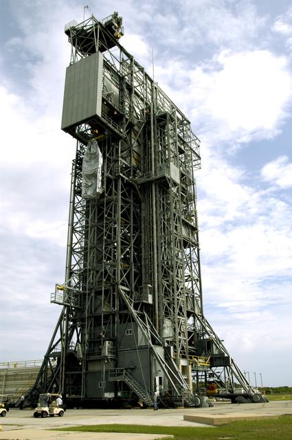 NASA image: KENNEDY SPACE CENTER, FLA. -  At Launch Complex 17-A, Cape Canaveral Air Force Station, the second half of the fairing for the Mars Exploration Rover 2 (MER-2/MER-A) nears the top of the launch tower.  The fairing will be installed around the payload for protection during launch on a Delta II rocket.  The MER Mission consists of two identical rovers designed to cover roughly 110 yards each Martian day over various terrain. Each rover will carry five scientific instruments that will allow it to search for evidence of liquid water that may have been present in the planet's past.  Identical to each other, the rovers will land at different regions of Mars.  Launch date for MER-A  is scheduled for June 5.