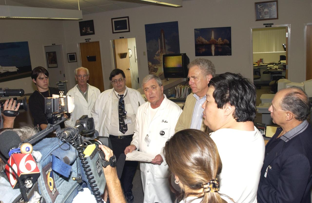 KENNEDY SPACE CENTER, FLA. -  George D'Heilly, with Instrumentation Technology Associates, Inc., Barry Perlman, with Pembroke Pines Middle School in Florida, John Cassanto, with ITA, and Lou Friedman, executive director of the Planetary Society, talk to the media about the experiments recovered during the search for Columbia debris.  They were part of the  Commercial ITA Biomedical Experiments payload on mission STS-107 that included the Growth of Bacterial Biofilm on Surfaces during Spaceflight (GOBBSS) experiment and crystals grown for cancer research.  The GOBBSS experiment was sponsored by the Planetary Society, with joint participation of an Israeli and a Palestinian student, and developed by the Israeli Aerospace Medical Institute and JSC Astrobiology Center.