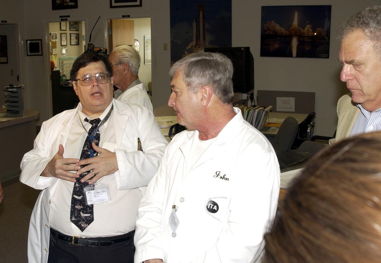 KENNEDY SPACE CENTER, FLA. -  Barry Perlman (left), with Pembroke Pines Charter Middle School in Florida, talks to the media about some of the experiments recovered during the search for Columbia debris.  At right are John Cassanto, with Instrumentation Technology Associates, Inc., and Lou Friedman, executive director of the Planetary Society.  The  Commercial ITA Biomedical Experiments payload on mission STS-107 included the Growth of Bacterial Biofilm on Surfaces during Spaceflight (GOBBSS) experiment and crystals grown for cancer research.  The GOBBSS experiment was sponsored by the Planetary Society, with joint participation of an Israeli and a Palestinian student, and developed by the Israeli Aerospace Medical Institute and JSC Astrobiology Center.
